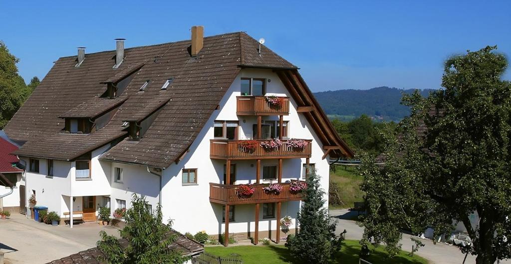 a large white building with a brown roof at Bauernhof Mayer in Owingen