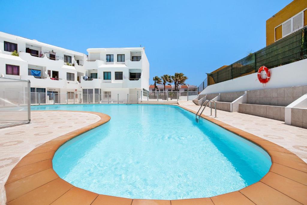 a swimming pool in front of a building at Casa Jable in Costa de Antigua