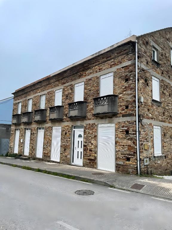a brick building with white doors and windows at Casa Adelina in Foz