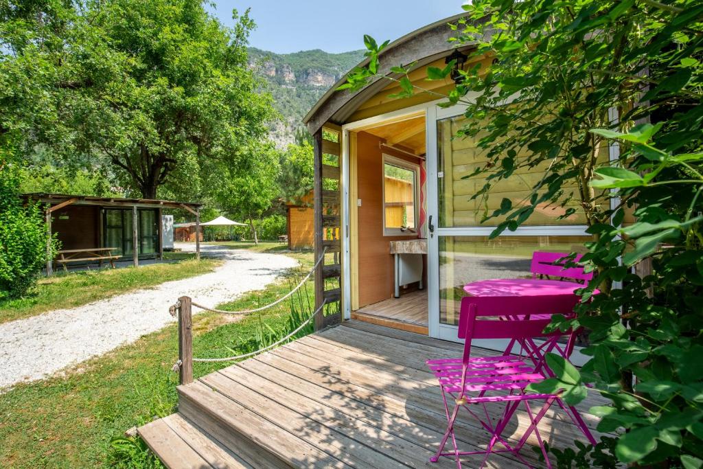 a house with a purple bench on a wooden porch at Roulotte insolite terrasse nature in Touët-sur-Var
