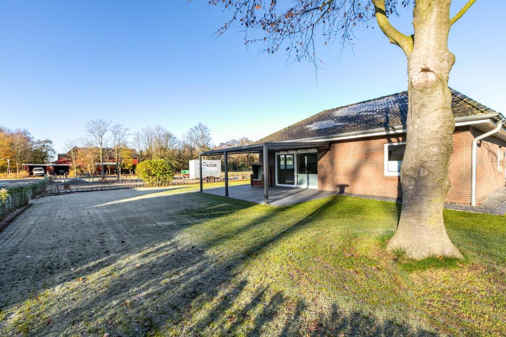 a building with a tree in front of it at Haus Luise in Bramstedtlund