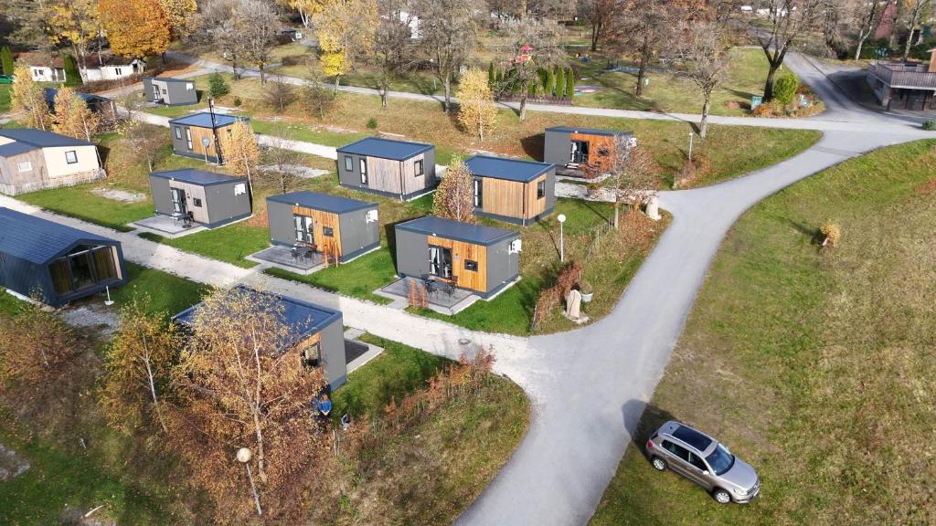 an aerial view of a house with a car on a road at Side-by-Side Tiny Houses in Untergriesbach