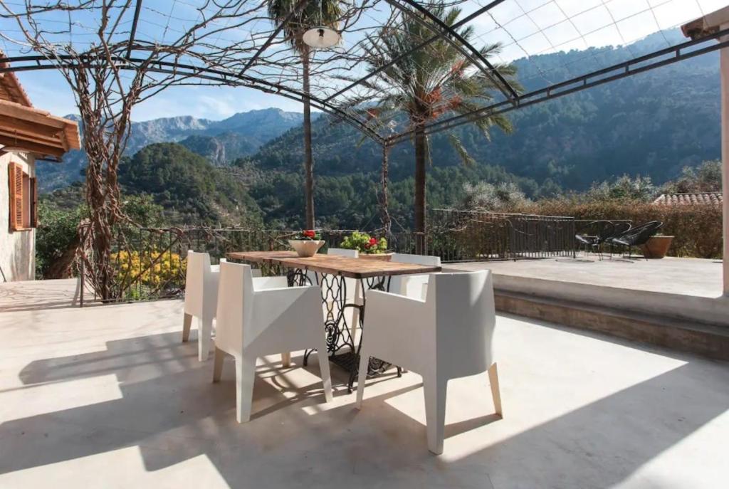 a table and chairs on a patio with a view at Can Garí in Sóller