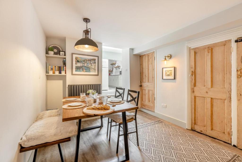 a dining room with a wooden table and chairs at 2 Bed in Appledore oc-cosyn in Appledore