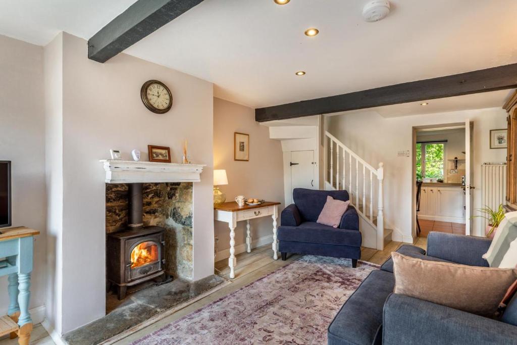 a living room with a fireplace and a couch at 2 Bed in Chideock oc-h29331 in Chideock