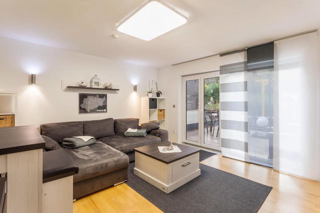 a living room with a couch and a table at Ferienwohnung Zur Quelle in Plettenberg