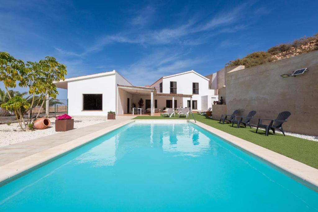 a swimming pool in front of a house at Villa Selena in Pájara