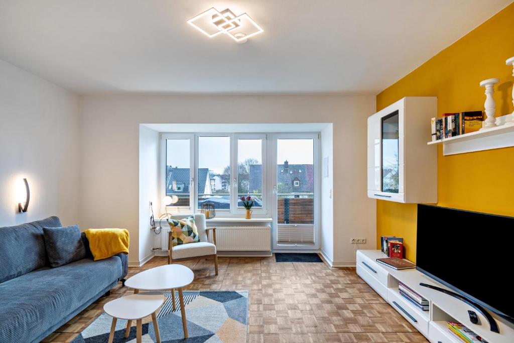 a living room with a couch and a tv at Apartement Hangarstein in Kassel