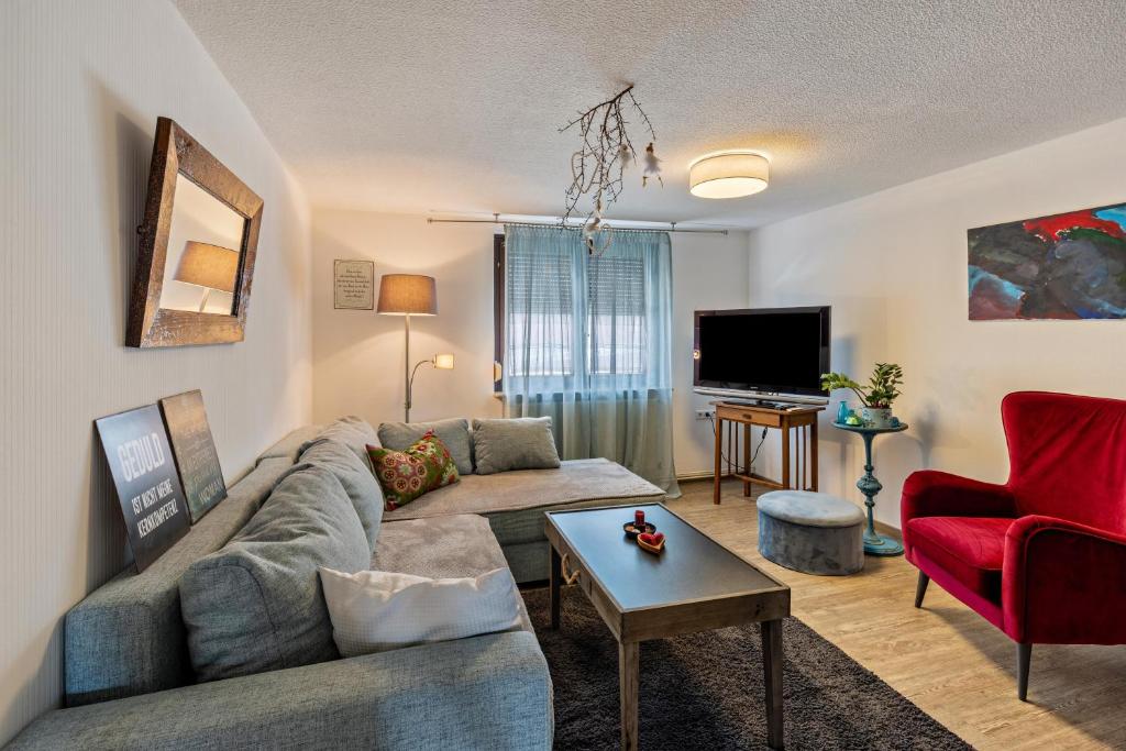 a living room with a couch and a tv at Ferienwohnung Zu Hause auf Zeit in Balingen