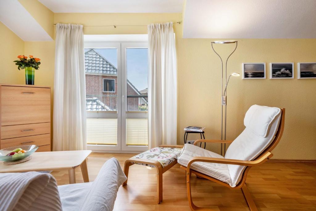 a room with a chair and a table and a window at Ferienwohnung 'Sonneck' in Eckernförde