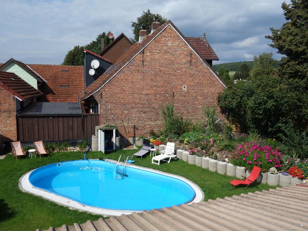 a swimming pool in the yard of a house at Gruppenhaus Osterhagen in Bad Lauterberg