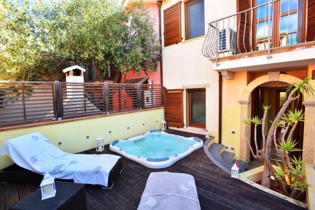a hot tub on the patio of a building at Luxury Guesthouse Pula in Pula