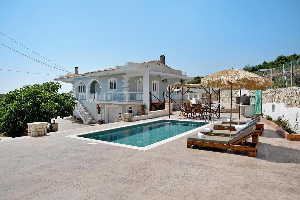a villa with a swimming pool and a house at Christine's House in Zakynthos