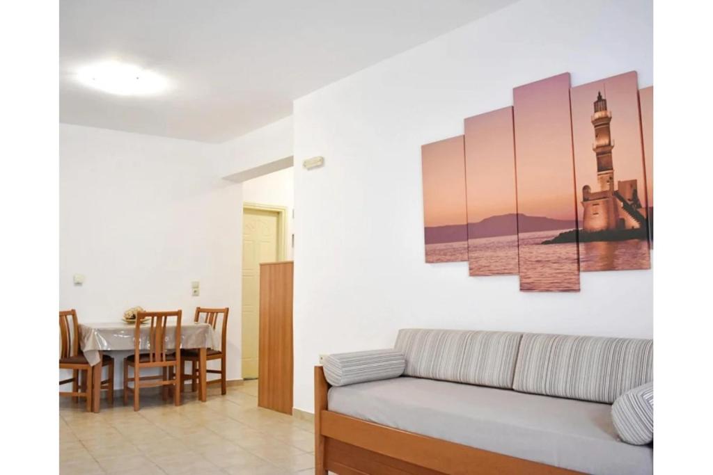 a living room with a couch and a table at Manolika Studio 1 in Kithnos