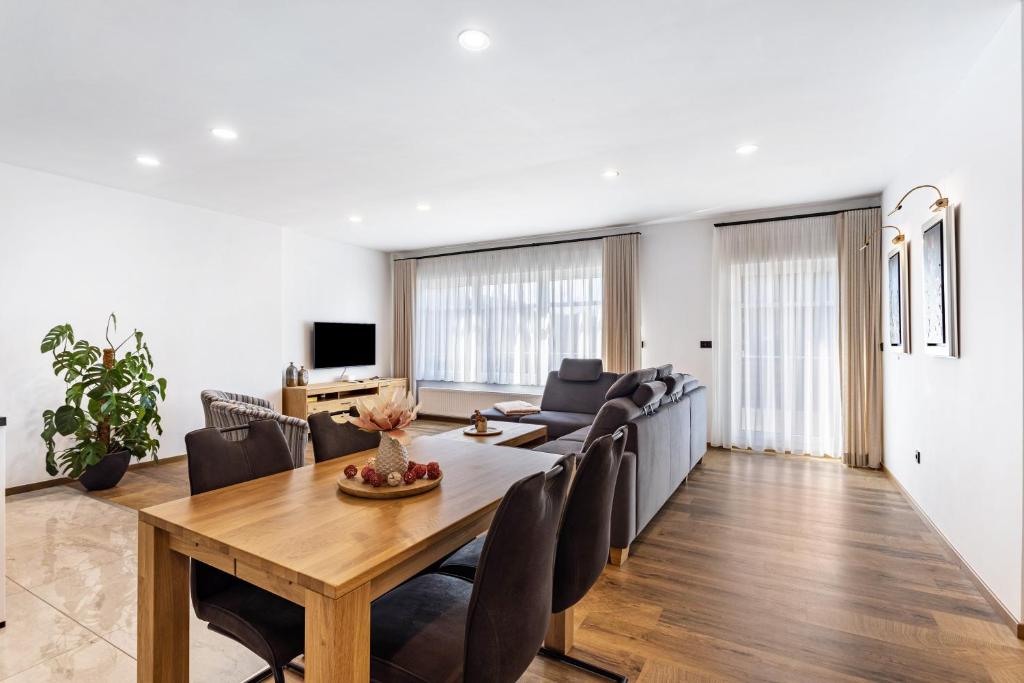 a dining room and living room with a table and chairs at Ferienwohnung Sophie Stecker in Schmallenberg