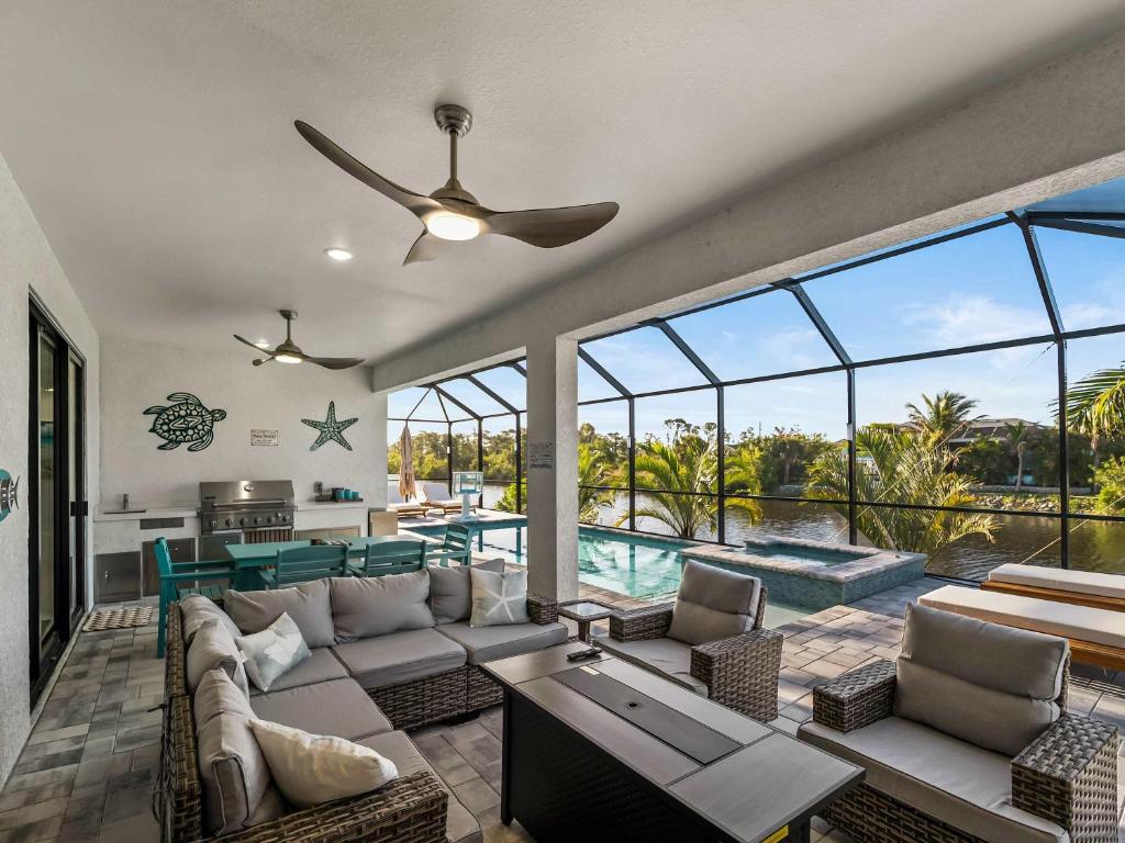 a living room with a couch and a ceiling fan at Waterfront Haven with Pool Spa Game Room in Port Charlotte