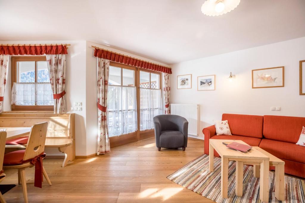 a living room with a couch and a table at Ciasa Tlara App Alma in San Vigilio Di Marebbe