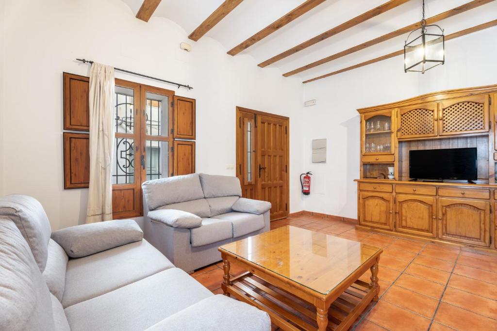 a living room with a couch and a coffee table at Cueva De La Portería in Chulilla