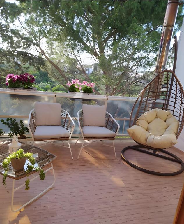 two chairs and a table on a balcony with flowers at La Dimora del Benessere in Noicattaro