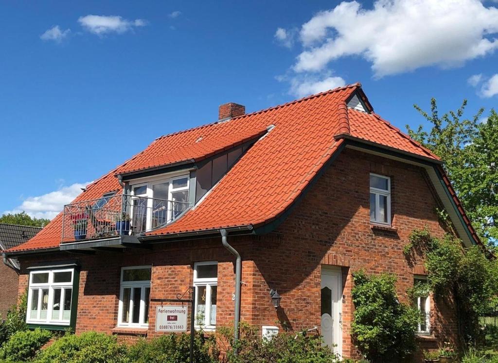a brick house with an orange roof at Ferienwohnung Schmilau in Schmilau