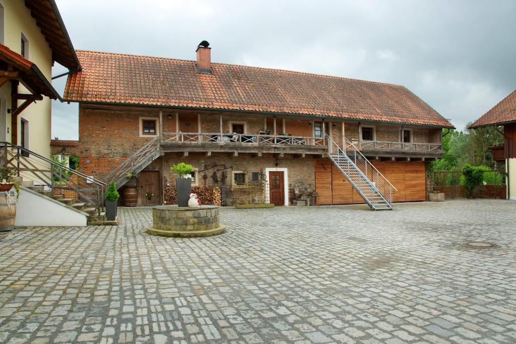 a large brick building with a staircase in front of it at Schönauer Hof - Wohnung Paula in Passau
