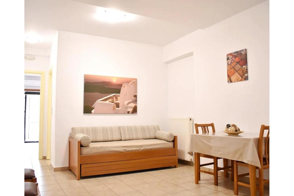 a living room with a couch and a table at Manolika Studio 6 in Kithnos