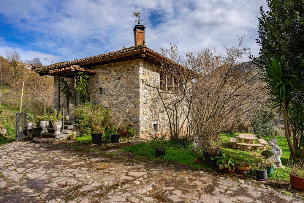 a large stone house with a roof at La Casa De La Torre in Dosango