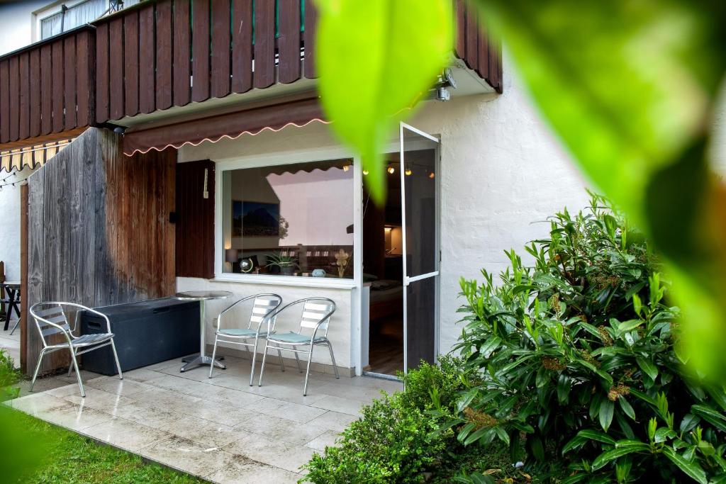 a patio with chairs and a counter in a house at Apartment Biendl in Mittenwald