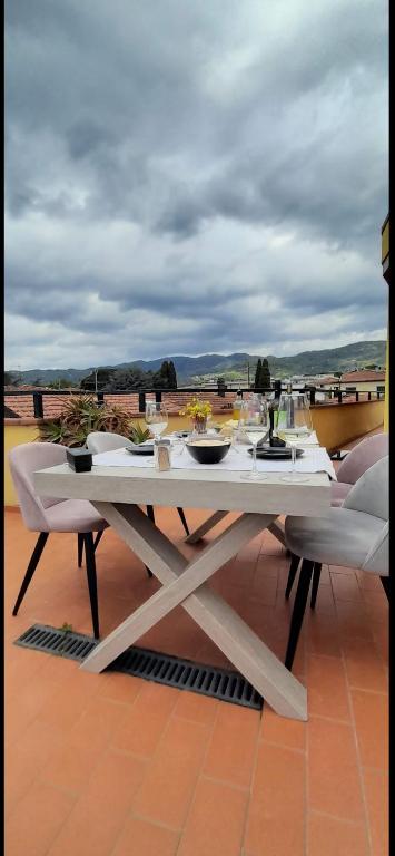 a white table with dishes on it on a roof at attico19 in Montecatini Terme