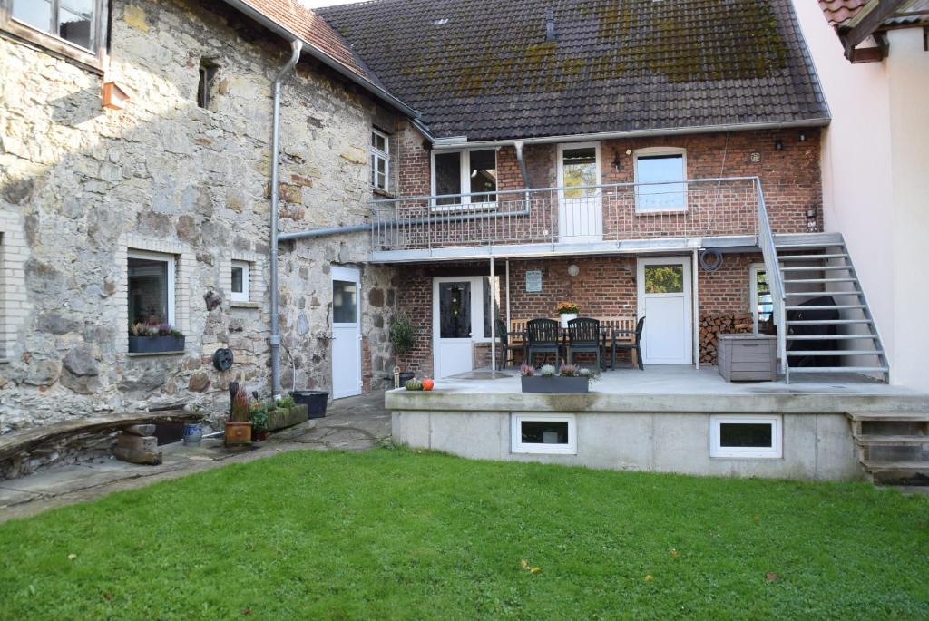 an external view of a stone house with a yard at Ferienwohnung in Lichtenau