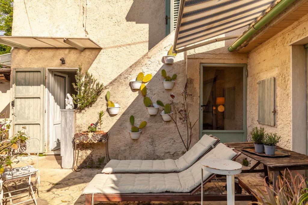 a patio with a couch and a table and some plants at Il Pescino in Pietrasanta