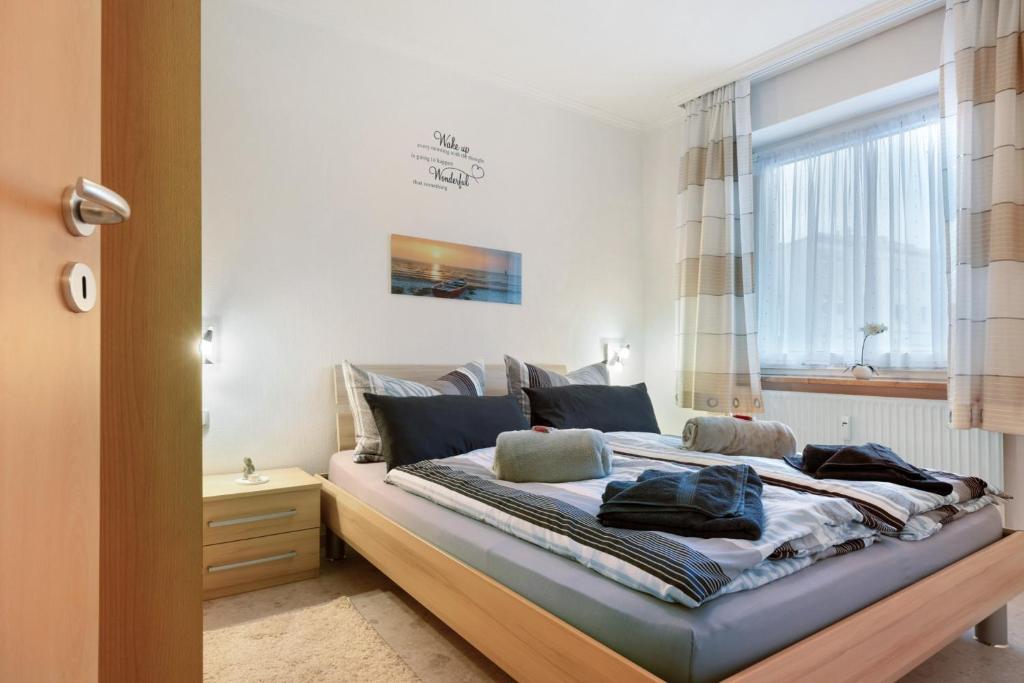 a bedroom with a large bed with a window at Haus Elbe 5 in Cuxhaven