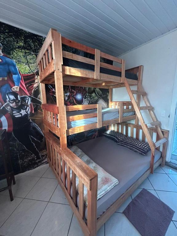 a wooden bunk bed in a room at Vila do Chaves Prof Girafales 15 in Itajaí