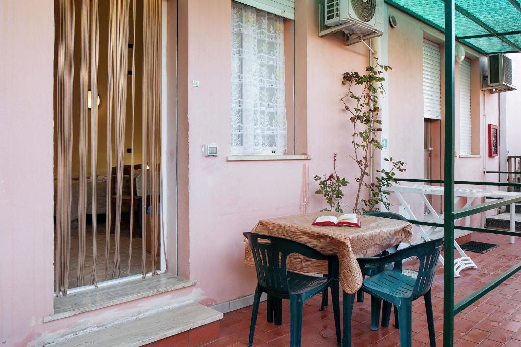 a table and two chairs on a balcony at Monolocale La Pineta 46 in Albenga