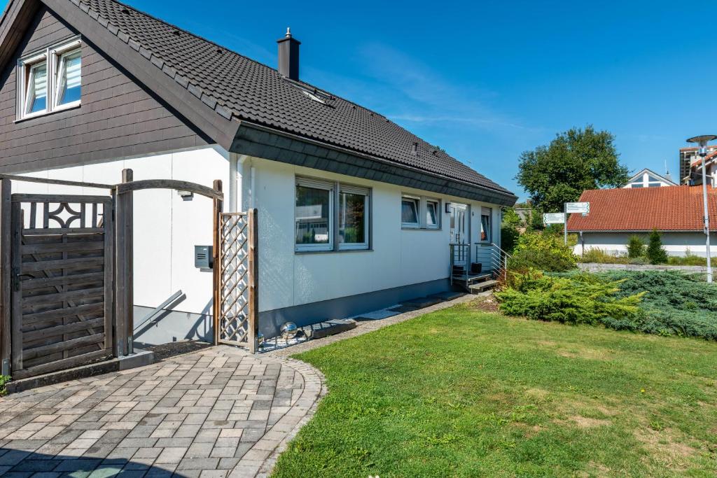 a small white house with a brown roof at Fewo Georg in Pfullendorf
