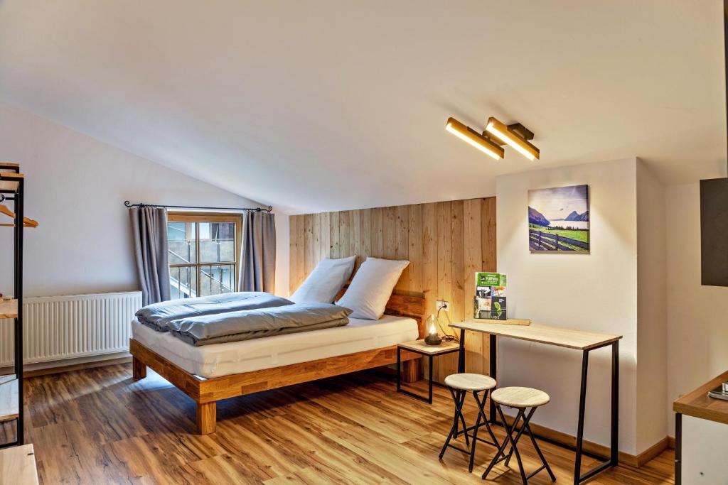 a bedroom with a bed and a desk at Appartement by Blahut Vacation - dg in Ehrwald