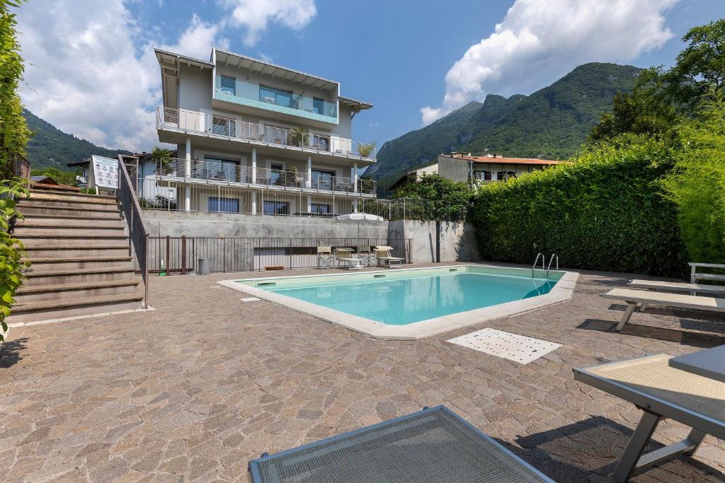 a swimming pool in front of a building at Eco del Garda Apartments in Tenno