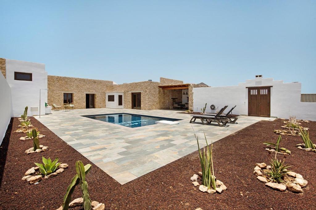 a backyard with a swimming pool and a house at Casa Rural Berrenda in Tiscamanita