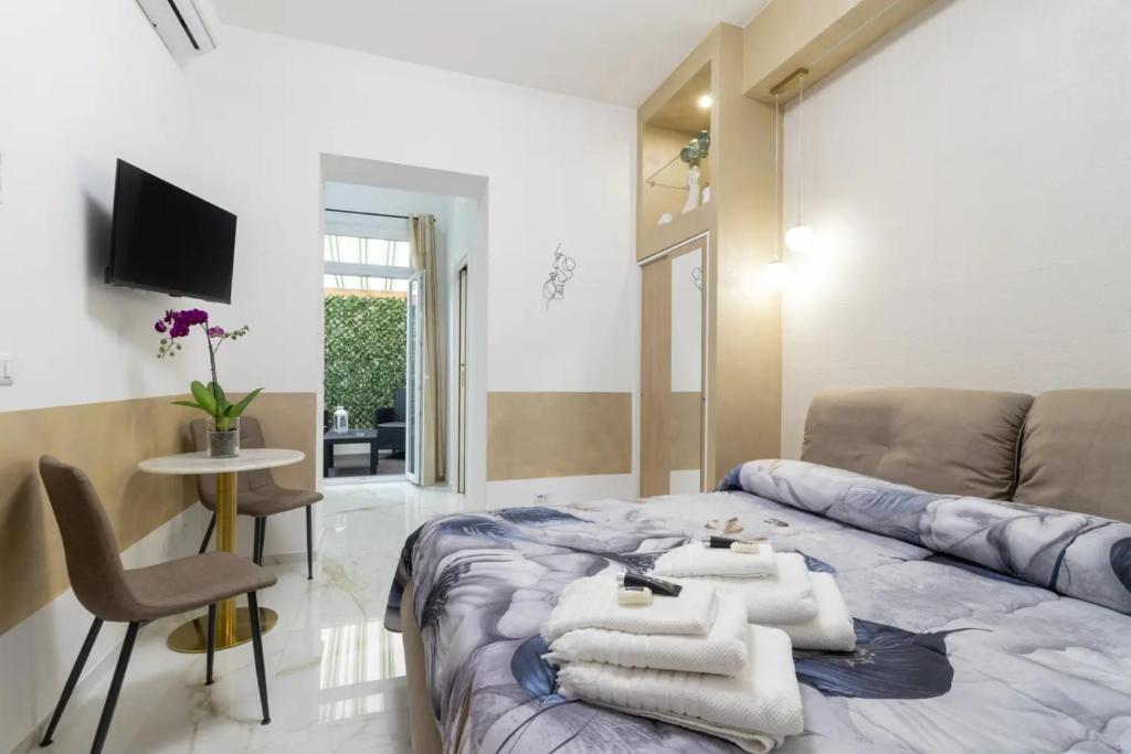 a room with a bed and a couch and a table at Eralight21 Apartments in Bari