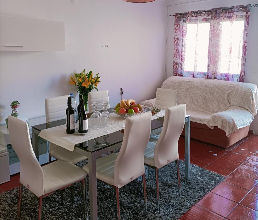 a dining room with a table and chairs and a bed at Valley T2 duplex in Vila Nova de Foz Coa
