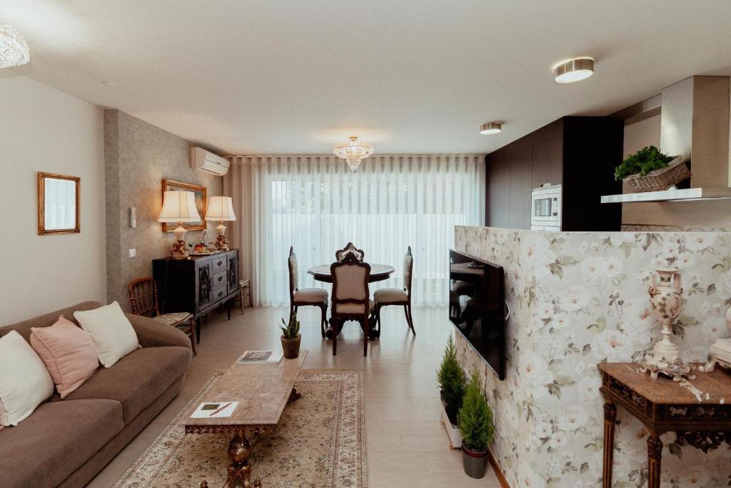 a living room with a couch and a table at Fonte do Pinheiro Boutique in Ponte de Lima