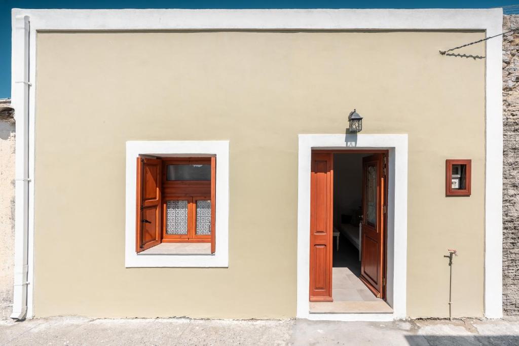 a white building with two doors and a window at Rodies House in Rhodes Town
