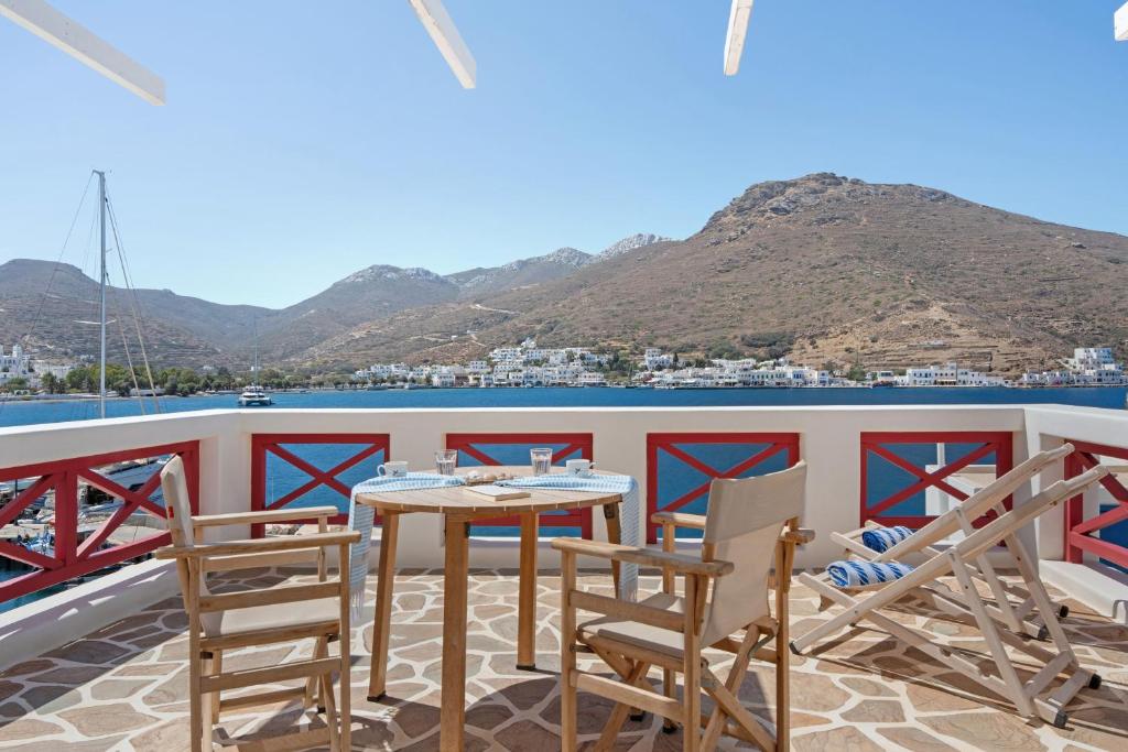 a table and chairs on a balcony with a view of the water at Nicolas House 1 in Rakhídhion