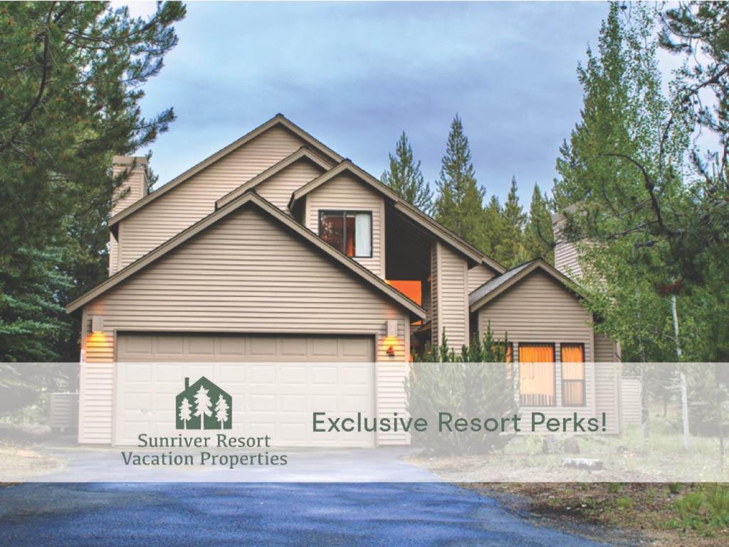 a house with a garage on a driveway at 4 Approach Lane in Sunriver