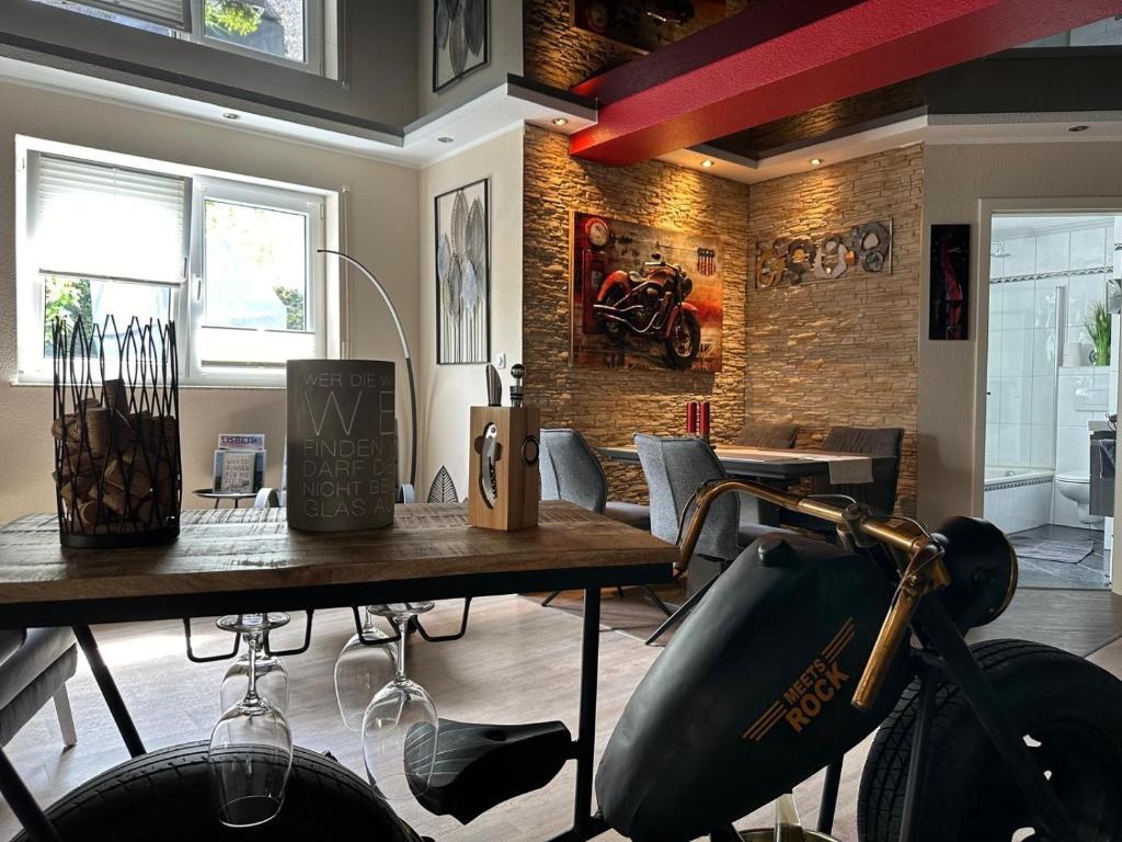 a room with a table with a motorcycle on the wall at Gemütliche Wohnung in Ortsrandlage in Rüdesheim am Rhein