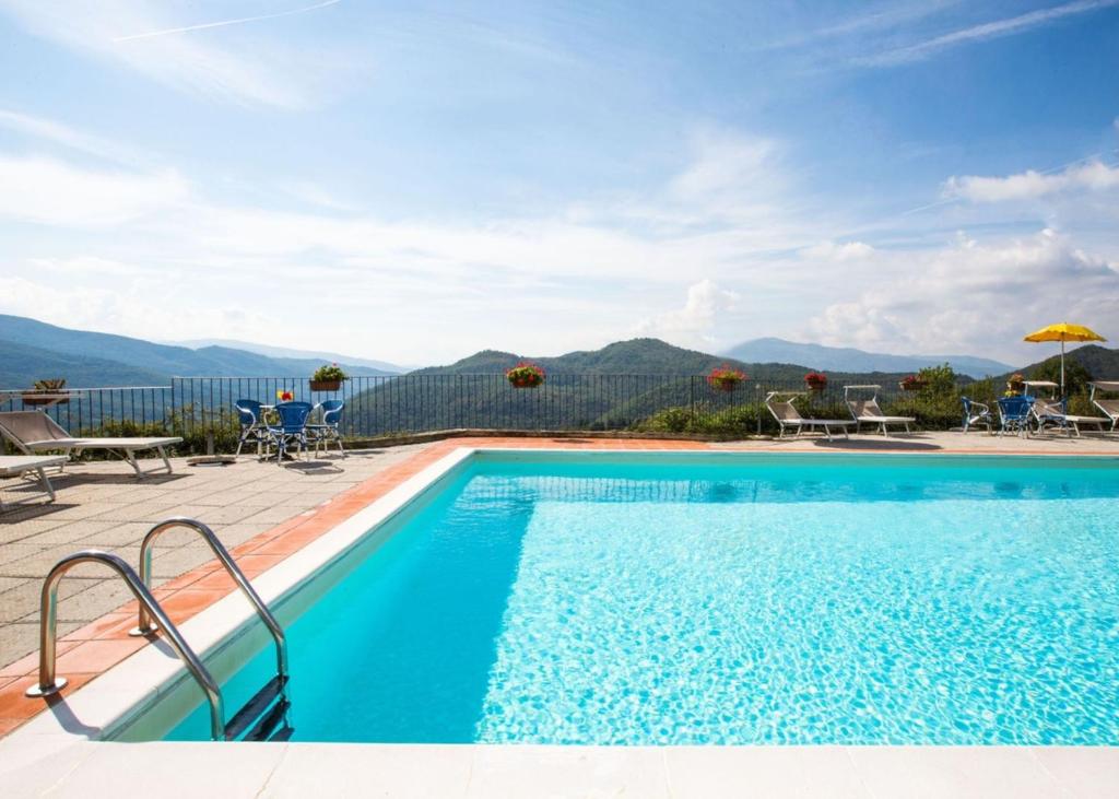 a swimming pool with a view of mountains at Universal Harmony - Usignolo in Dicomano