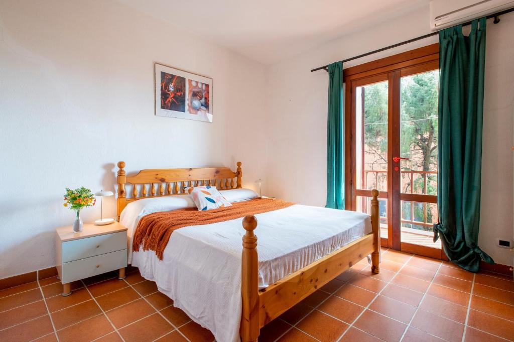 a bedroom with a bed and a large window at Pentavano White House in Isola Rossa