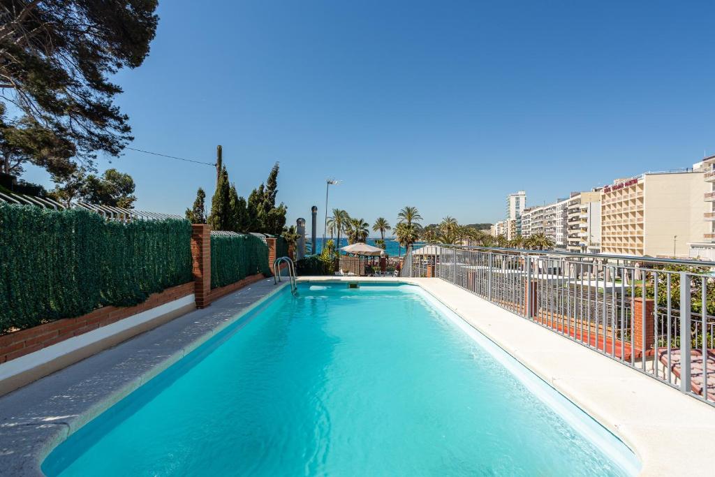a swimming pool with blue water on top of a building at S23 Sa Caleta in Lloret de Mar