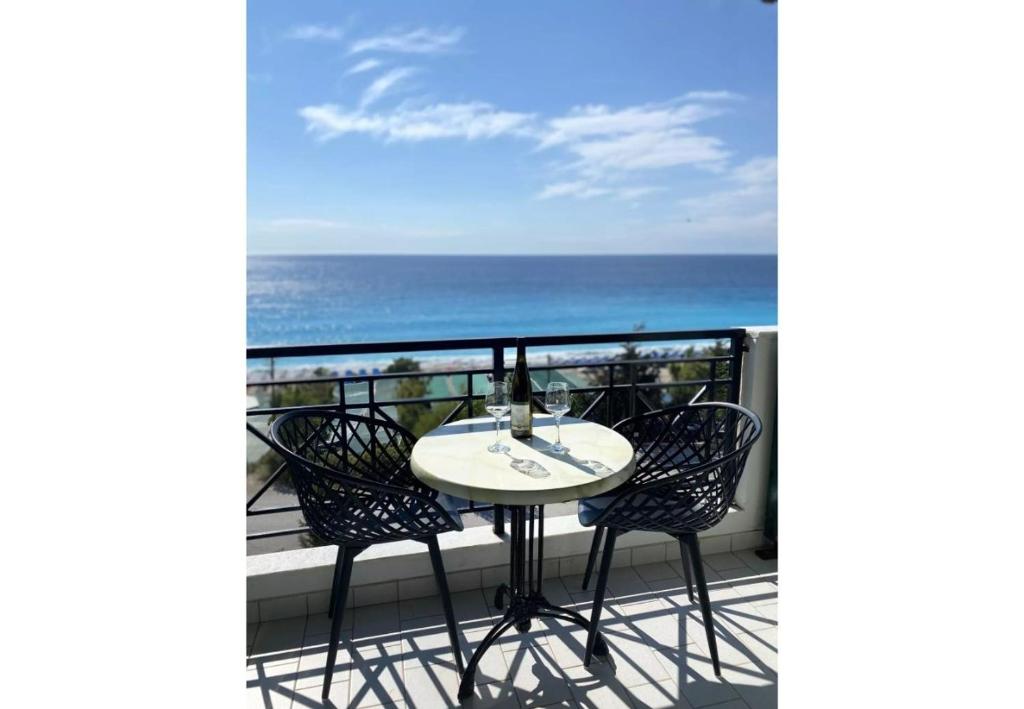 a table and chairs on a balcony with the ocean at Sunset Premium Studio 4 in Lefkada