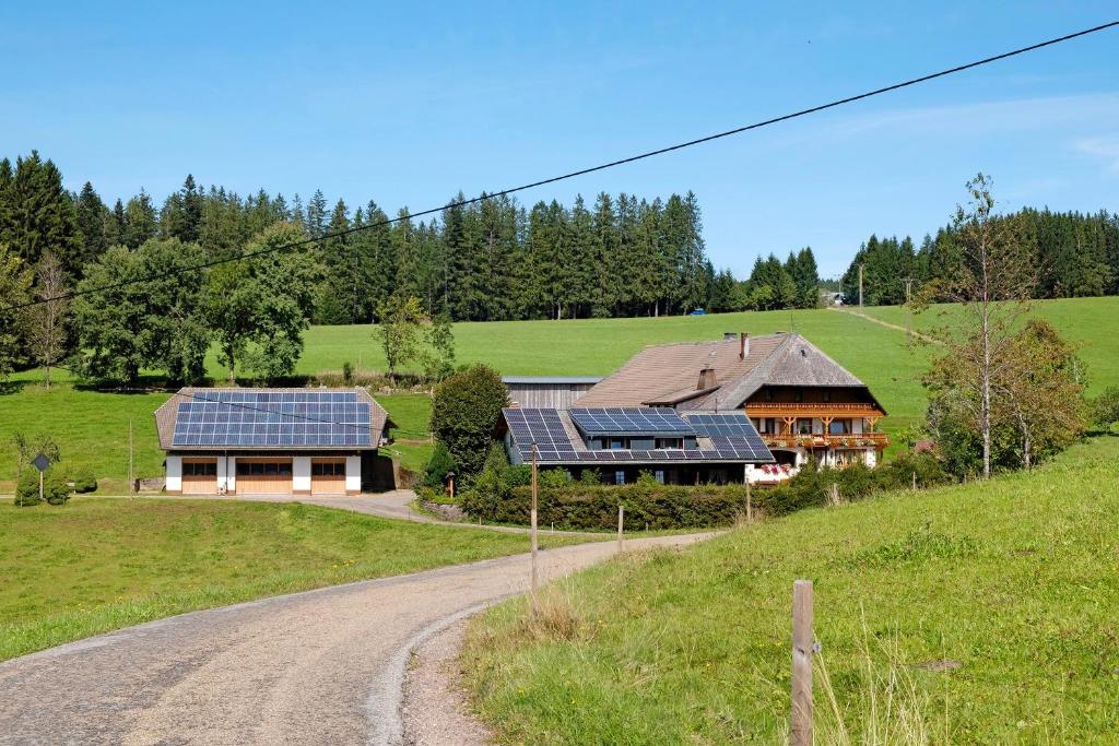 a house with solar panels on the side of a road at Willmannshof in Furtwangen